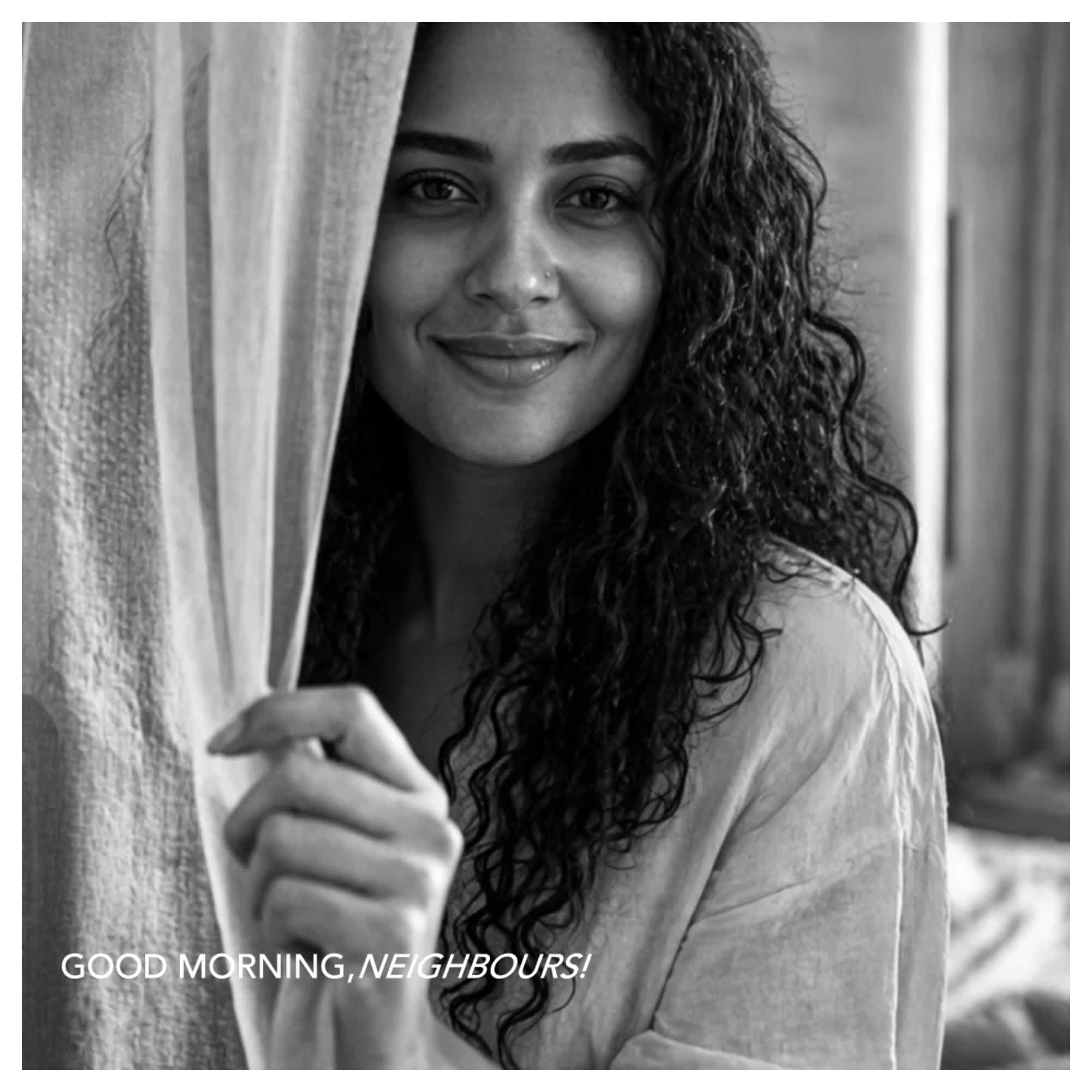 Still from Good Morning, Neighbours: the resident smiling from behind the curtain