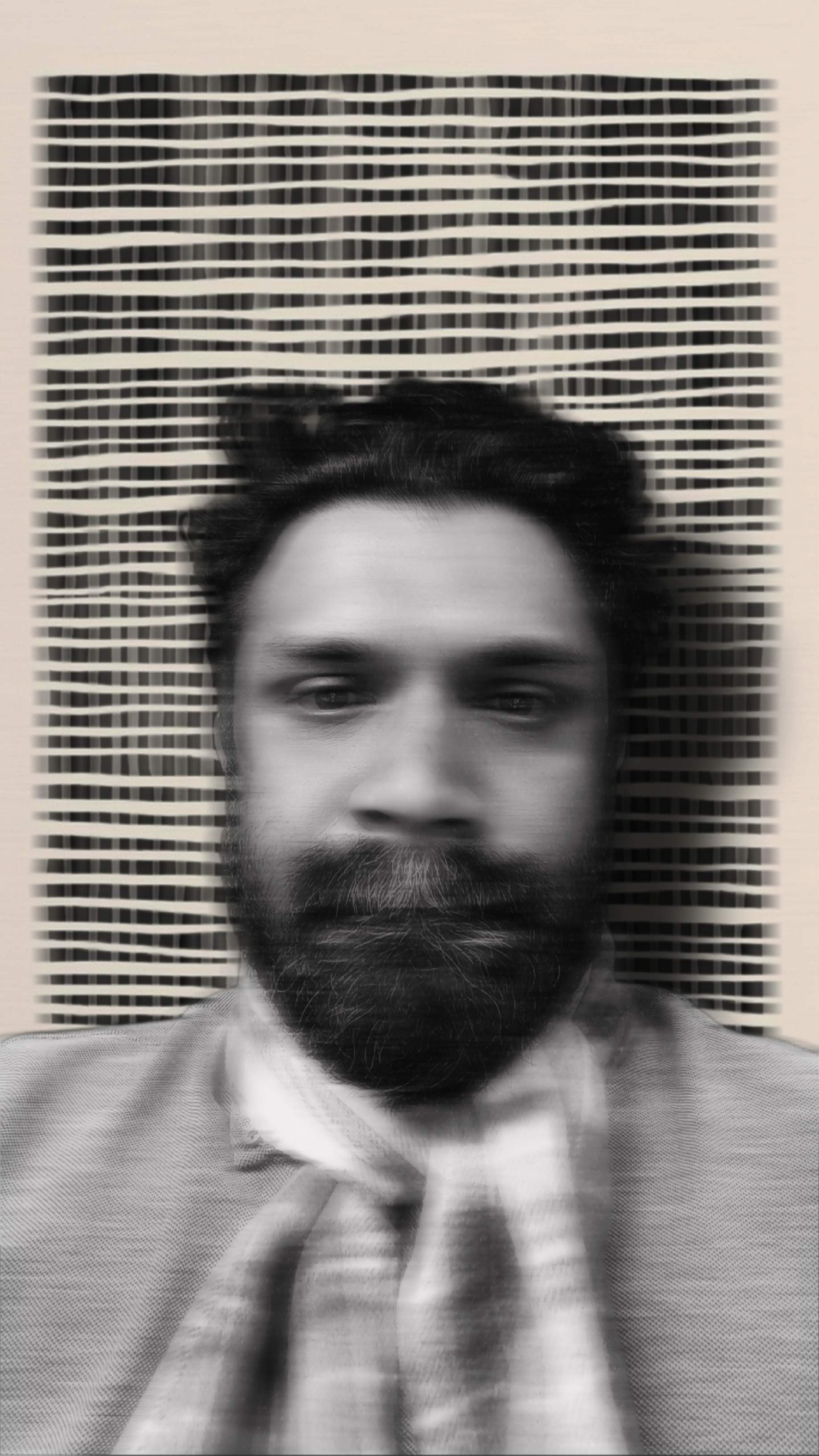 The author before a woven black and bone textile panel, soft focus